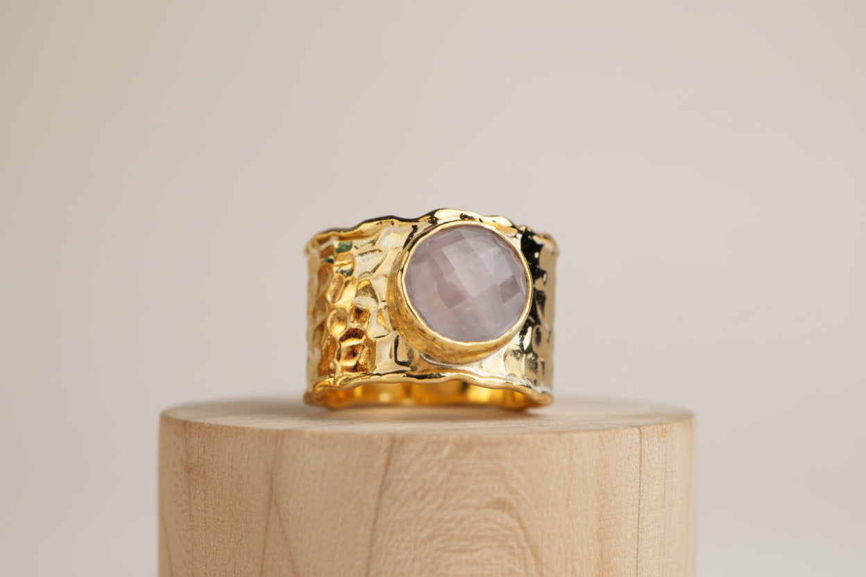 Ring with gemstone placed on a wooden surface