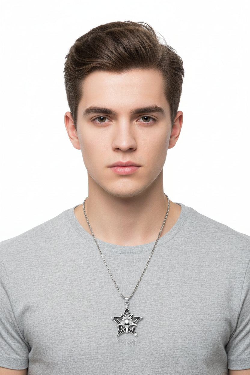 Silver star-shaped pendant on a chain against a white background