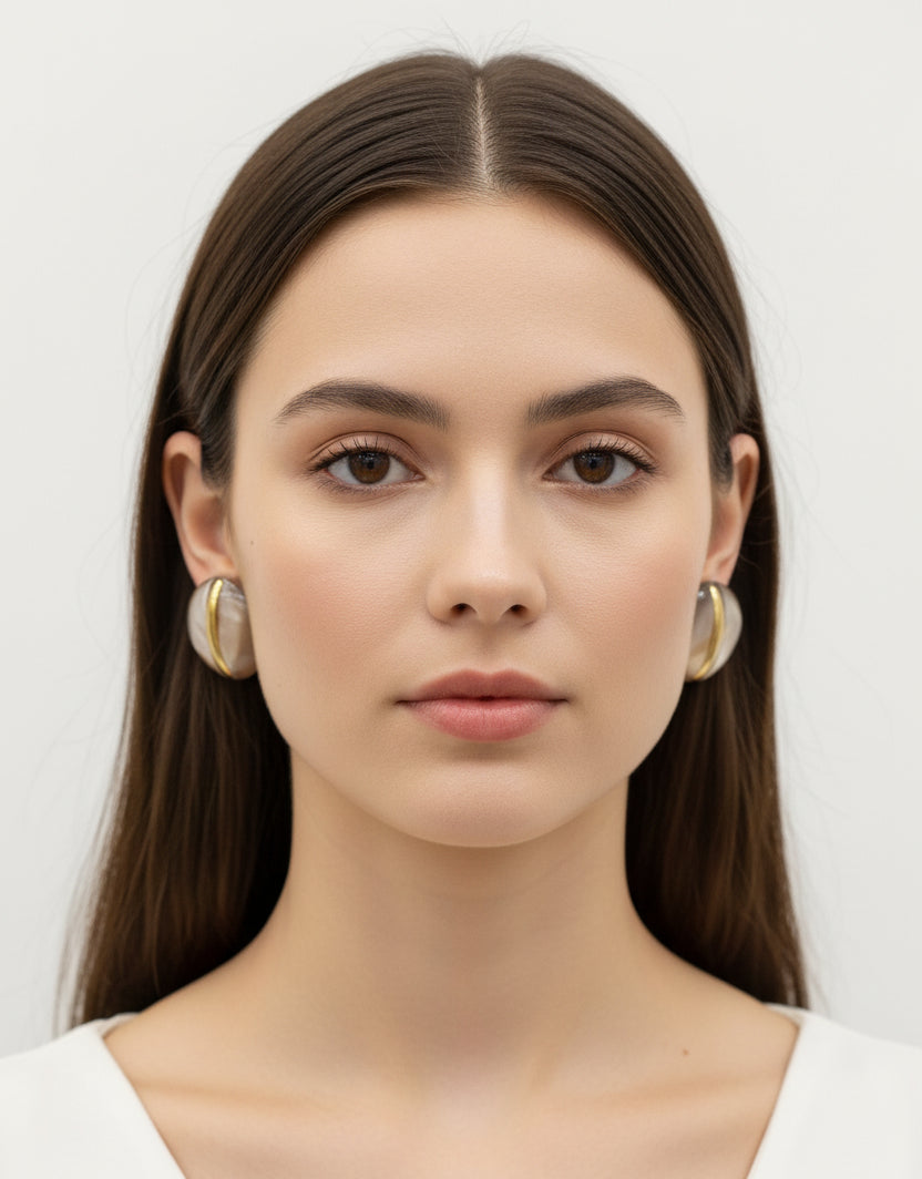Pair of earrings with gold and brown design on a white background