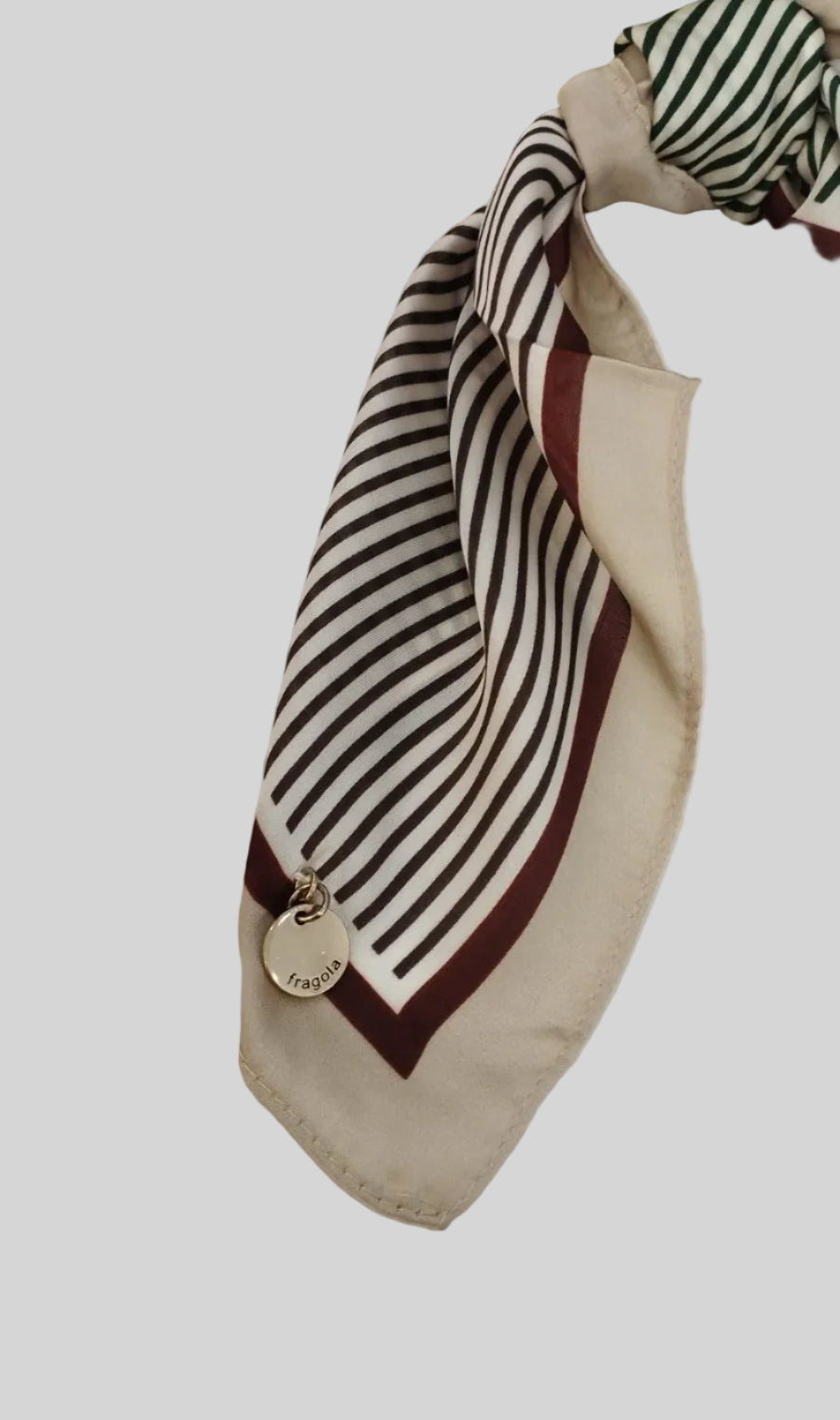 Striped scarf with a knot on a white surface