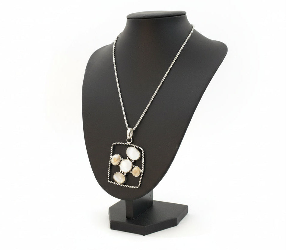 Necklace with a pendant on a black mannequin bust against a neutral background