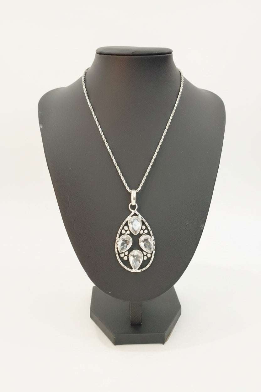 Silver necklace with a pendant on a black mannequin bust.